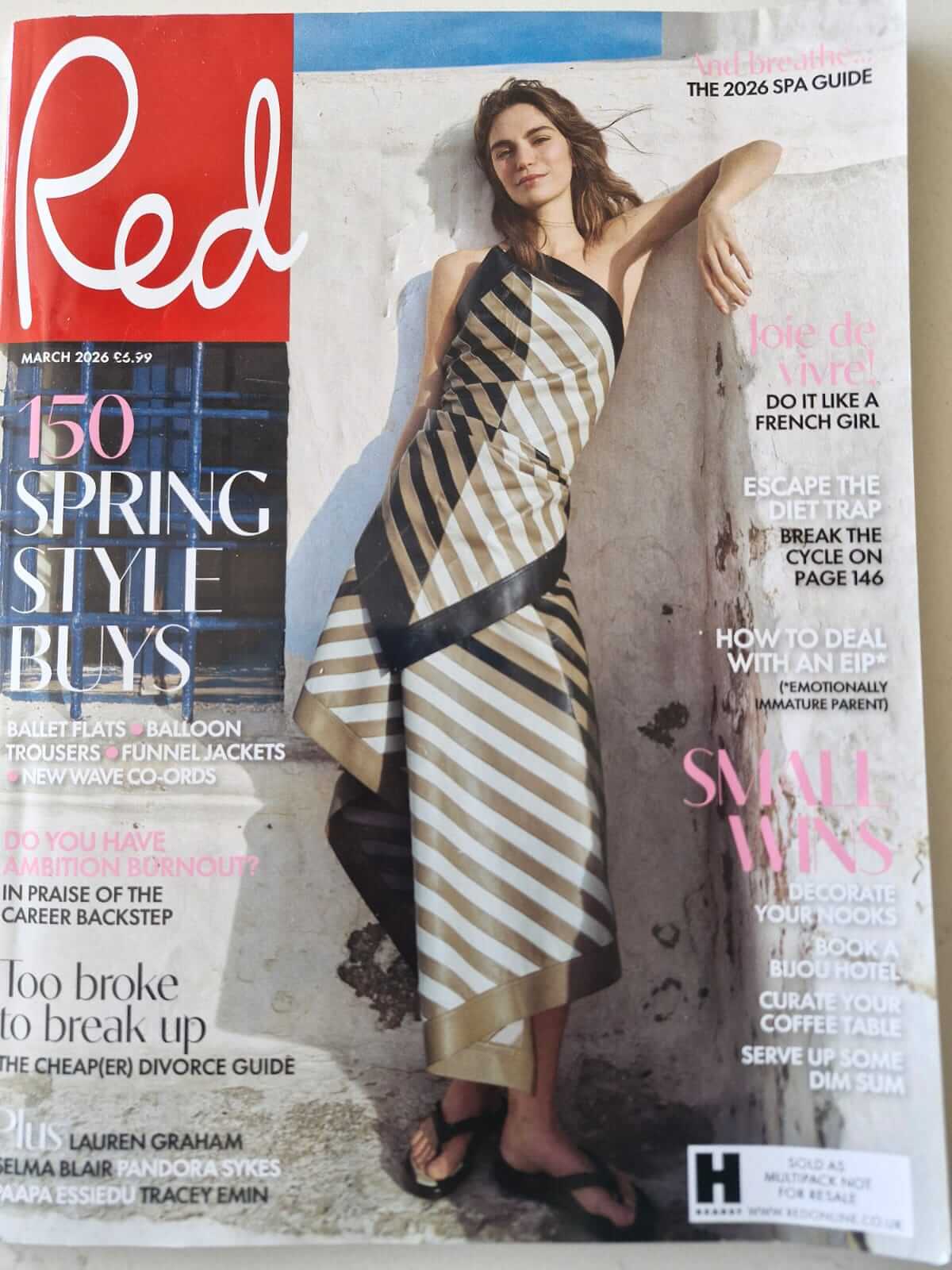 Cover of Red magazine March 2026 issue featuring person in striped beige, white, and black dress with flip‑flops against summery backdrop, highlighting spring style buys, lifestyle features, and career advice.